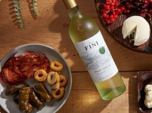 Barone Fini Pinot Grigio with food on table